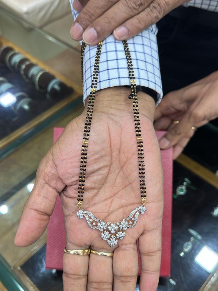 Raw phone photo of a diamond mangalsutra, taken in-store